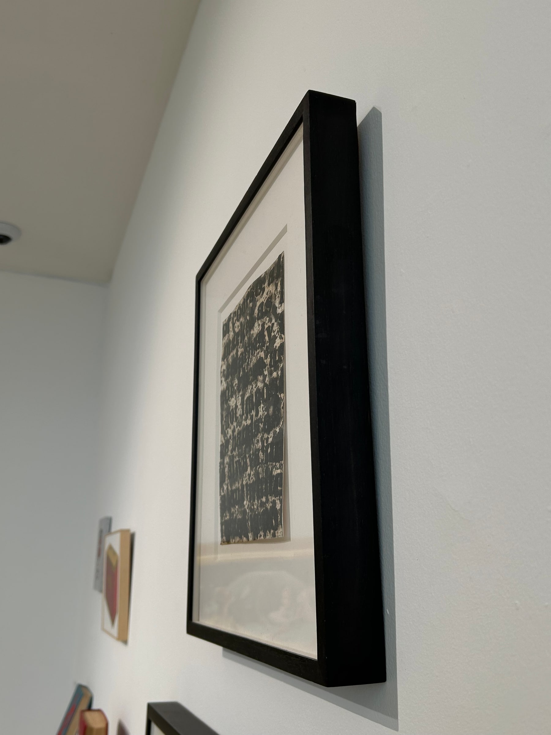 Glenn Ligon, Study for “White Series” (1995). Oblique installation view, showing the depth of the black frame.