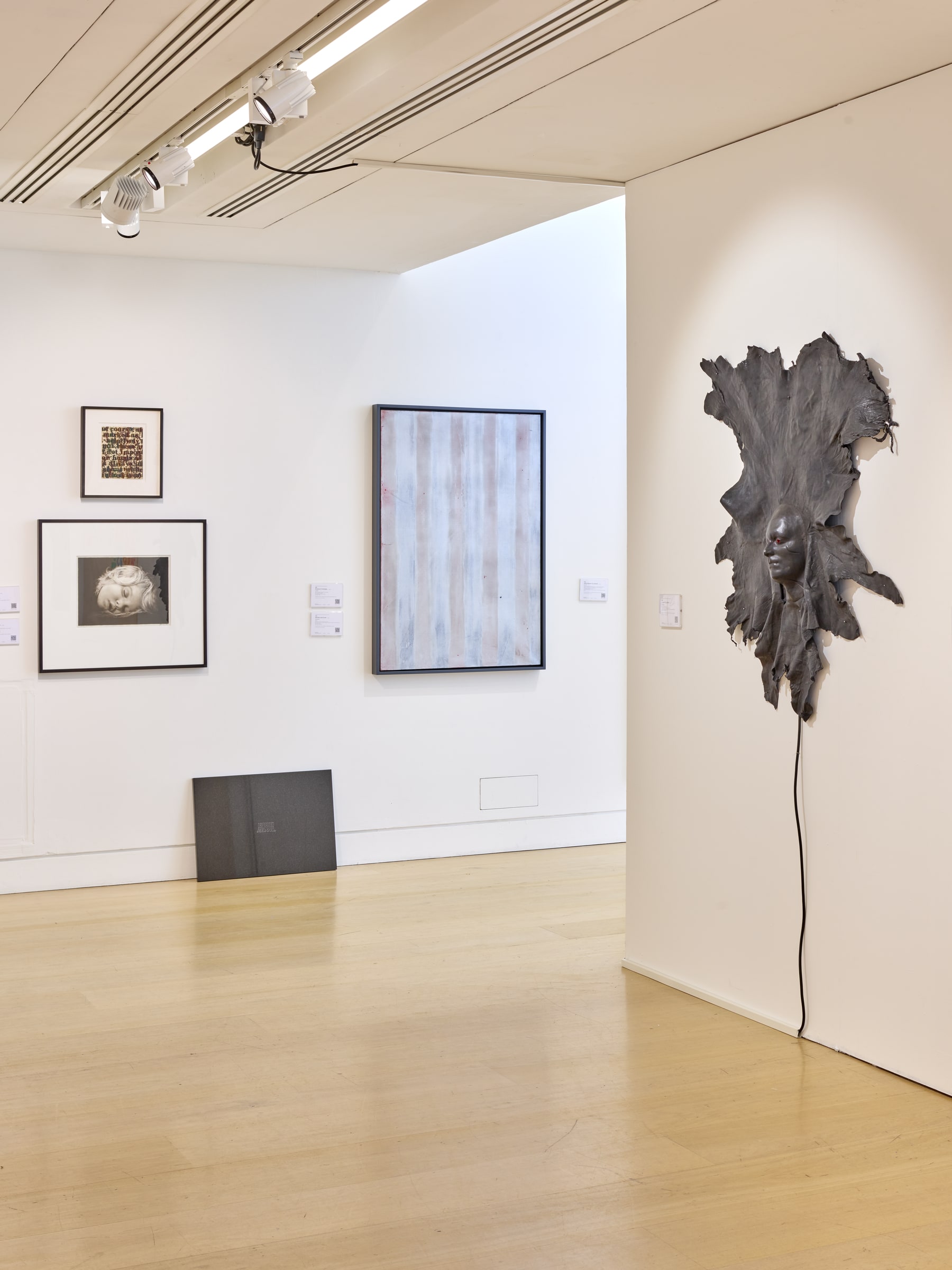 Glenn Ligon, Study for “White Series” (1995). Gallery installation view. The work hangs on the far-left wall above another framed work.