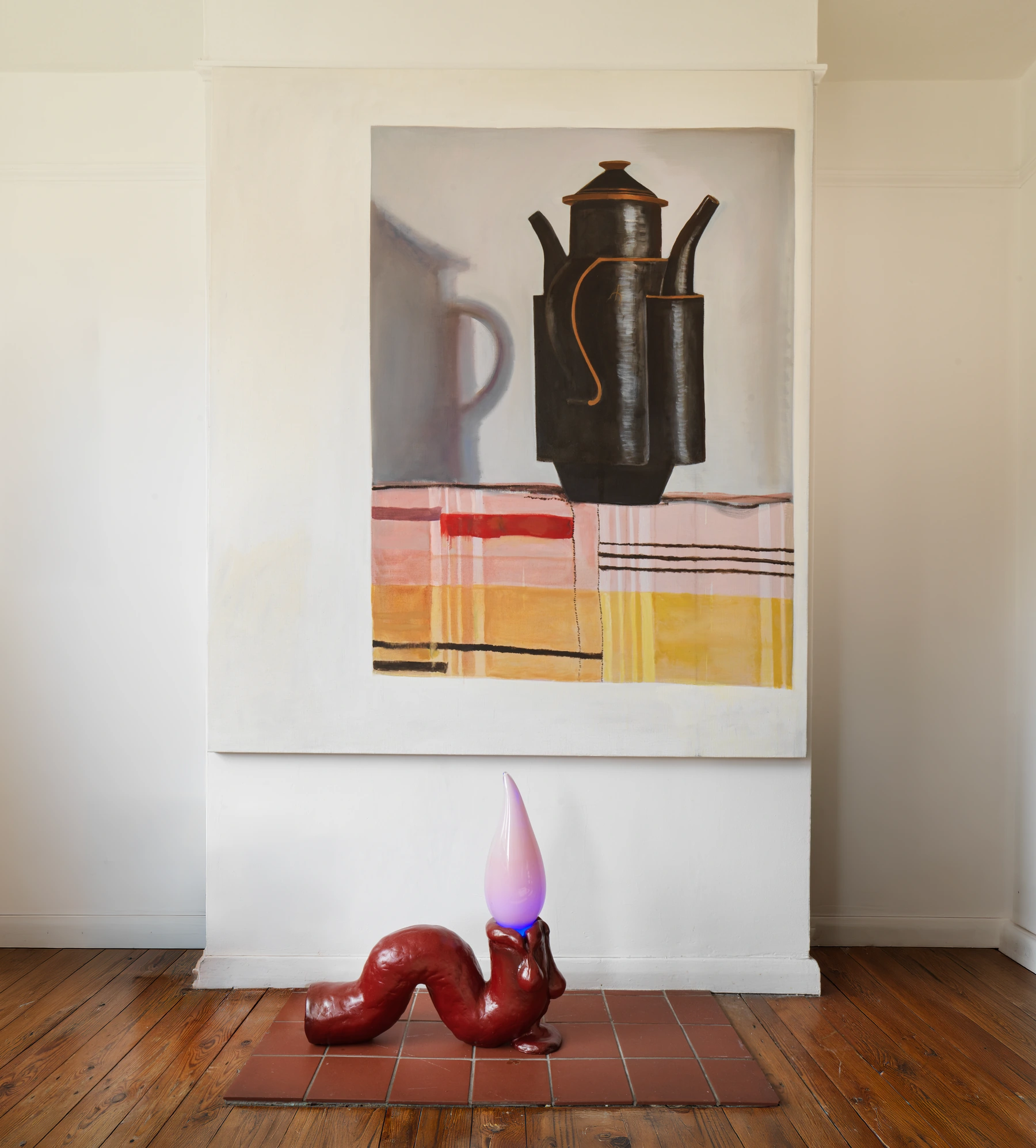A large painting of dark vessels above a red sculptural form with an illuminated purple tip, installed together in a domestic interior